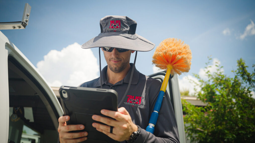 The Bug Terminators technician inspecting property